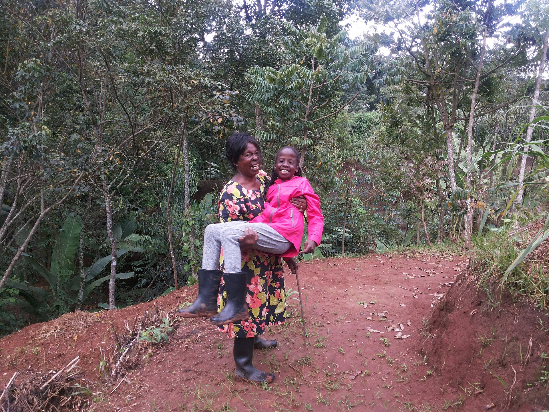 Placeholder photo: a community member planting tree seedlings