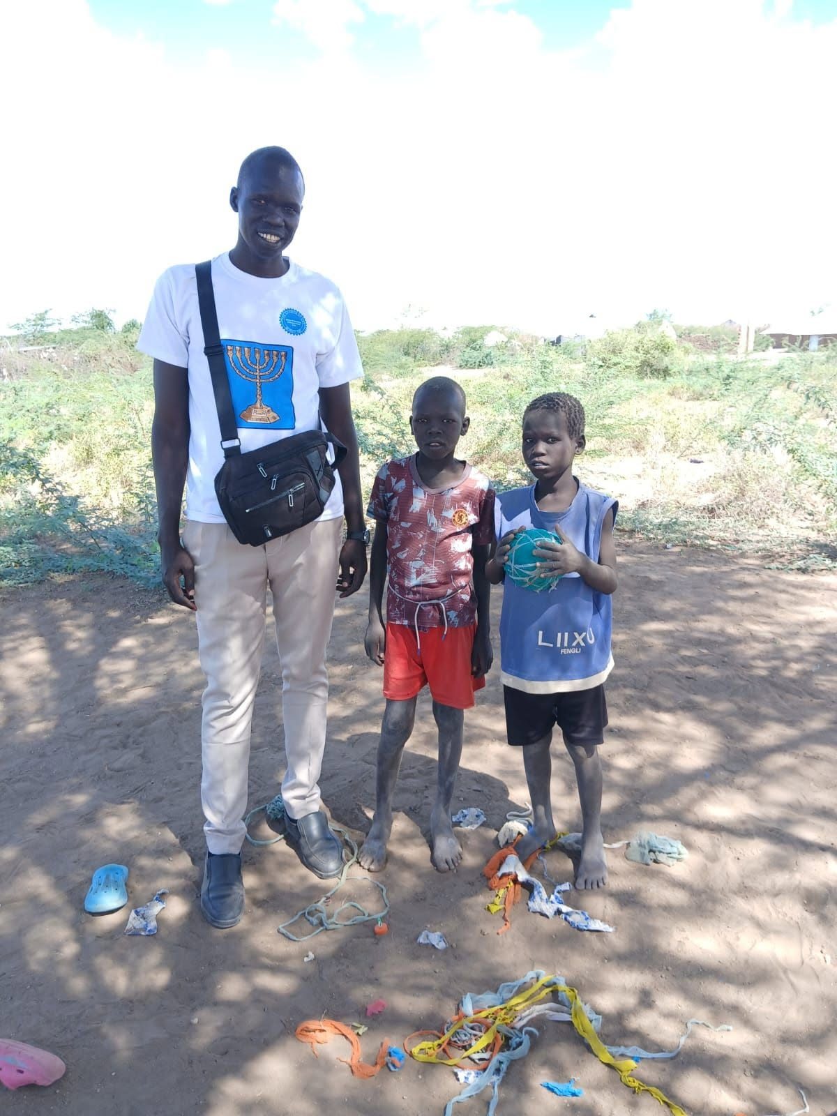 Placeholder photo: young footballers holding a ball with their coach